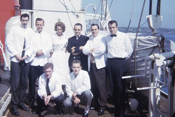 Steward Lloyd Batt (bottom centre-right of frame) poses with his ship at the wharf in Gaultois.
